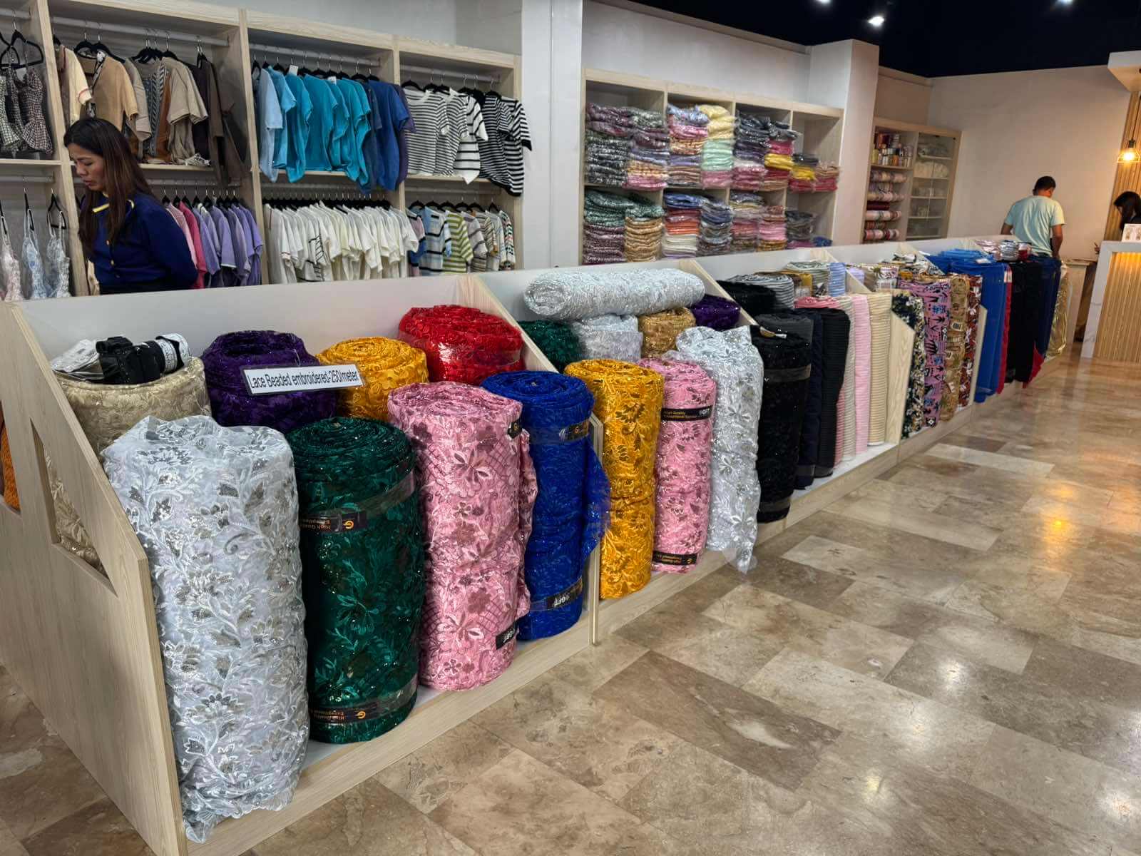 Rolled bolts of colorful fabric on display